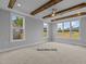 Bedroom with natural lighting, tray ceiling with wooden beams, and carpet flooring at 5100 Grist Stone Way, Youngsville, NC 27596