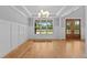 Bright dining room featuring hardwood floors, large windows, and decorative trim at 5100 Grist Stone Way, Youngsville, NC 27596