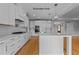 Spacious kitchen featuring white cabinets, stainless steel appliances, and a large kitchen island at 5100 Grist Stone Way, Youngsville, NC 27596