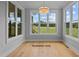 Sunroom with large windows providing natural light and views of the backyard at 5100 Grist Stone Way, Youngsville, NC 27596