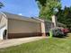 House exterior with brick foundation, garage, and a small deck, alongside yard at 6220 Sweden Dr, Raleigh, NC 27612