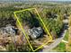 Aerial view of the home inside the estimated property lines, surrounded by wooded land at 181 Colonial Ridge Dr, Pittsboro, NC 27312