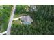 Aerial shot of a house with a well-manicured lawn and lots of tall trees at 181 Colonial Ridge Dr, Pittsboro, NC 27312
