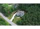 Aerial shot of a house with a long driveway, surrounded by lots of trees at 181 Colonial Ridge Dr, Pittsboro, NC 27312