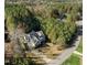 Aerial view of a well-maintained home surrounded by dense trees and a long driveway at 181 Colonial Ridge Dr, Pittsboro, NC 27312