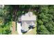 Overhead view of a home with intricate rooflines, nestled among dense trees and greenery at 181 Colonial Ridge Dr, Pittsboro, NC 27312