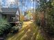 Backyard showing the screen porch and a path leading into the woods at 181 Colonial Ridge Dr, Pittsboro, NC 27312
