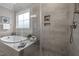 Modern bathroom features a soaking tub, glass-enclosed shower, and decorative niches at 181 Colonial Ridge Dr, Pittsboro, NC 27312