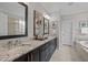 Elegant bathroom with dual sinks, granite countertops, and stylish vanity, offering a luxurious experience at 181 Colonial Ridge Dr, Pittsboro, NC 27312