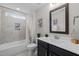 Bathroom with a tub and shower, a window bringing in natural light, and a dark wooden vanity at 181 Colonial Ridge Dr, Pittsboro, NC 27312