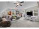 Spacious bonus room with a comfortable sectional, large television, and plenty of natural light at 181 Colonial Ridge Dr, Pittsboro, NC 27312