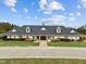 A clubhouse with a dark shingled roof, well maintained landscaping, and ample parking at 181 Colonial Ridge Dr, Pittsboro, NC 27312
