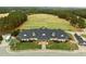 Aerial view of a golf course clubhouse with lush landscaping and ample parking at 181 Colonial Ridge Dr, Pittsboro, NC 27312