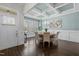 Bright dining room with coffered ceiling, modern chandelier, and ample natural light from large windows at 181 Colonial Ridge Dr, Pittsboro, NC 27312