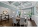 A dining room with modern chandelier, wainscoting, and a console table adds charm to this space at 181 Colonial Ridge Dr, Pittsboro, NC 27312