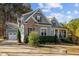 Charming home featuring a partial brick facade, light blue siding, and a well-manicured lawn and driveway at 181 Colonial Ridge Dr, Pittsboro, NC 27312