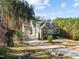 Exterior elevation of the home with a long driveway, a 3-car garage, and a well manicured yard at 181 Colonial Ridge Dr, Pittsboro, NC 27312