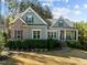 Attractive home with lush landscaping, stone steps, and a welcoming front porch for relaxing at 181 Colonial Ridge Dr, Pittsboro, NC 27312