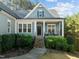 Lovely home with charming front porch featuring white columns and a comfortable seating area at 181 Colonial Ridge Dr, Pittsboro, NC 27312