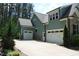 Three-car garage with a spacious driveway surrounded by greenery at 181 Colonial Ridge Dr, Pittsboro, NC 27312