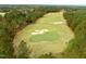 Aerial shot of a golf course with sand traps and putting greens surrounded by trees at 181 Colonial Ridge Dr, Pittsboro, NC 27312