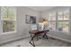 Bright home office with a modern desk, comfortable chair, and a large window with natural light at 181 Colonial Ridge Dr, Pittsboro, NC 27312