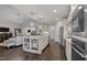 Open concept kitchen with large center island featuring a sink, open shelving, and pendant lighting at 181 Colonial Ridge Dr, Pittsboro, NC 27312