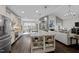 Spacious kitchen with modern appliances and a large island flowing into a cozy living space at 181 Colonial Ridge Dr, Pittsboro, NC 27312