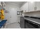 Well-organized laundry room with modern washer and dryer, ample cabinet space, and convenient bench seating at 181 Colonial Ridge Dr, Pittsboro, NC 27312