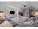 Spacious living area with modern finishes, a large sectional couch, and a TV with plenty of natural light at 181 Colonial Ridge Dr, Pittsboro, NC 27312
