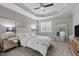 Serene main bedroom features a plush bed, a mirrored dresser and large windows for ample natural light at 181 Colonial Ridge Dr, Pittsboro, NC 27312
