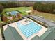 Aerial view of a community pool with tennis courts, playground, and ample parking at 181 Colonial Ridge Dr, Pittsboro, NC 27312