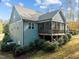 Back exterior of house with screened-in porch and tidy landscaping at 181 Colonial Ridge Dr, Pittsboro, NC 27312