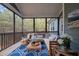 Relaxing screened porch with comfortable seating, a stylish rug, and scenic wooded views at 181 Colonial Ridge Dr, Pittsboro, NC 27312