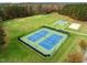 Aerial view of tennis and basketball courts with lush surrounding greenery and fall foliage backdrop at 181 Colonial Ridge Dr, Pittsboro, NC 27312
