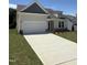 Attractive single-Gathering home with a gray accent gable, a two-car garage, and a concrete driveway at 579 Winding Creek Dr, Lillington, NC 27546