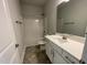 This bathroom features a vanity, a shower-tub combination, and neutral paint at 60 Falls Of The Cape Dr, Lillington, NC 27546