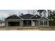 Charming new construction featuring a brick facade, attached garage, and a welcoming front entrance at 60 Falls Of The Cape Dr, Lillington, NC 27546