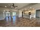 Open living area with hardwood floors flowing to the kitchen and dining spaces at 60 Falls Of The Cape Dr, Lillington, NC 27546