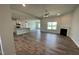 Open floor plan featuring hardwood floors and views into the kitchen at 60 Falls Of The Cape Dr, Lillington, NC 27546