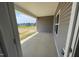 A covered patio with a view of the partially developed backyard at 60 Falls Of The Cape Dr, Lillington, NC 27546