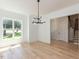 Bright, airy dining room with modern chandelier, hardwood floors, and plenty of natural light at 103 Brandy Ml, Pittsboro, NC 27312