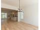 Bright, airy dining room with modern chandelier, hardwood floors, and view into the kitchen at 103 Brandy Ml, Pittsboro, NC 27312