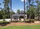 Beautiful two-story home with neutral siding, dark roof, and lush landscaping nestled between mature trees at 103 Brandy Ml, Pittsboro, NC 27312