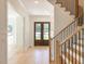 Inviting foyer featuring a wood staircase with black metal railings and a wood double front door at 103 Brandy Ml, Pittsboro, NC 27312
