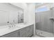 Modern bathroom with double vanity, large shower, and gray tile at 444 Billingshurst Way, Knightdale, NC 27545