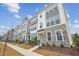 New townhome community with multiple units, stone and gray siding at 444 Billingshurst Way, Knightdale, NC 27545