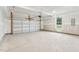 Spacious two-car garage with concrete floor at 444 Billingshurst Way, Knightdale, NC 27545