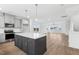 Modern kitchen with island, stainless steel appliances, and white cabinets at 444 Billingshurst Way, Knightdale, NC 27545