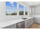 Modern kitchen with white cabinets and quartz countertops at 444 Billingshurst Way, Knightdale, NC 27545